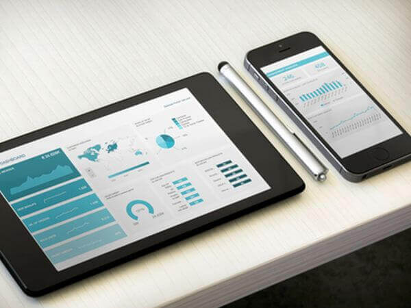 tablet and smartphone displaying corporate dashboards on their screens